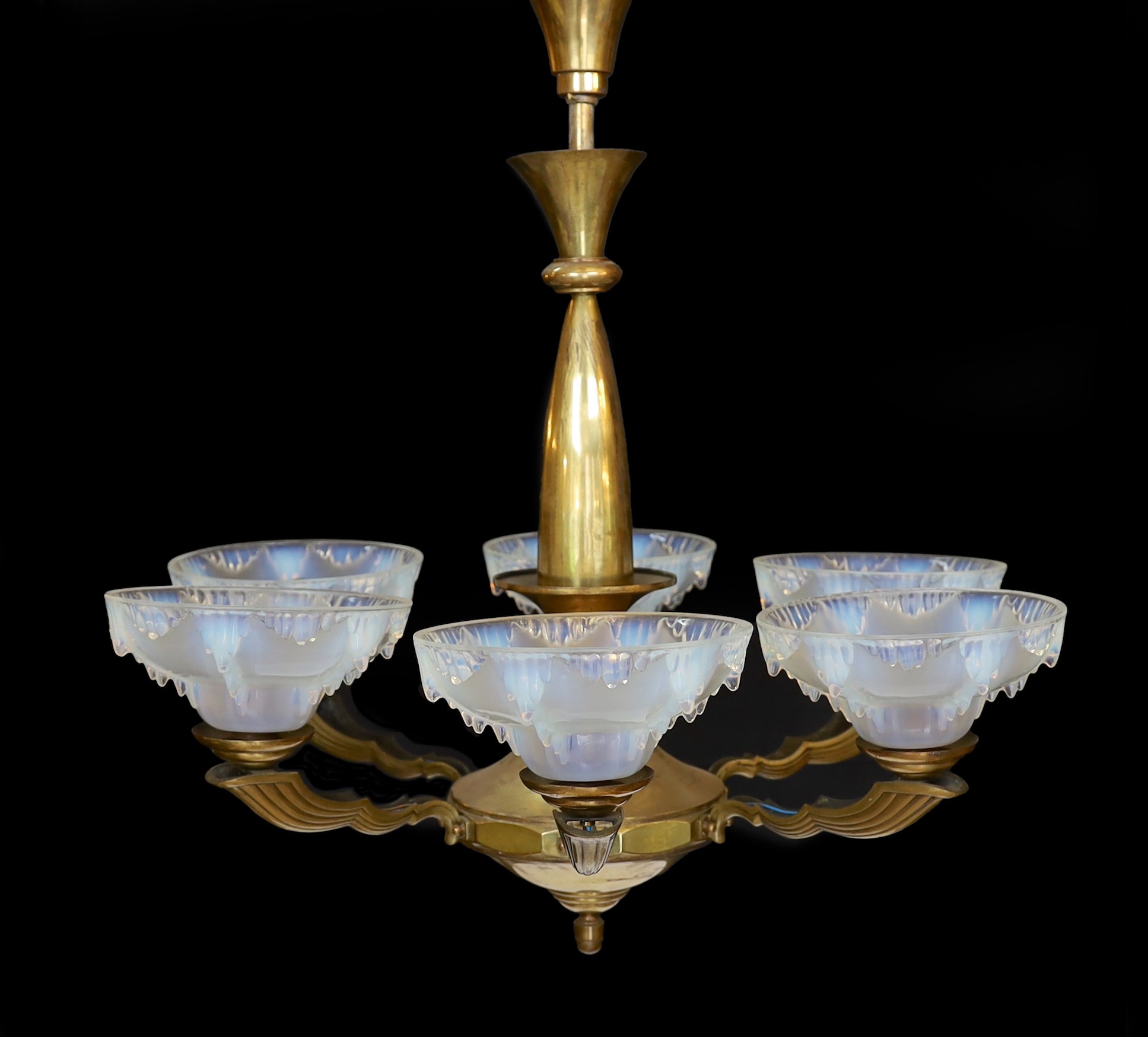 A French Art Deco bronze and opalescent glass six light chandelier by Ezan, with scrolling branches and ‘melting ice‘ shades, height 80cm. width 70cm